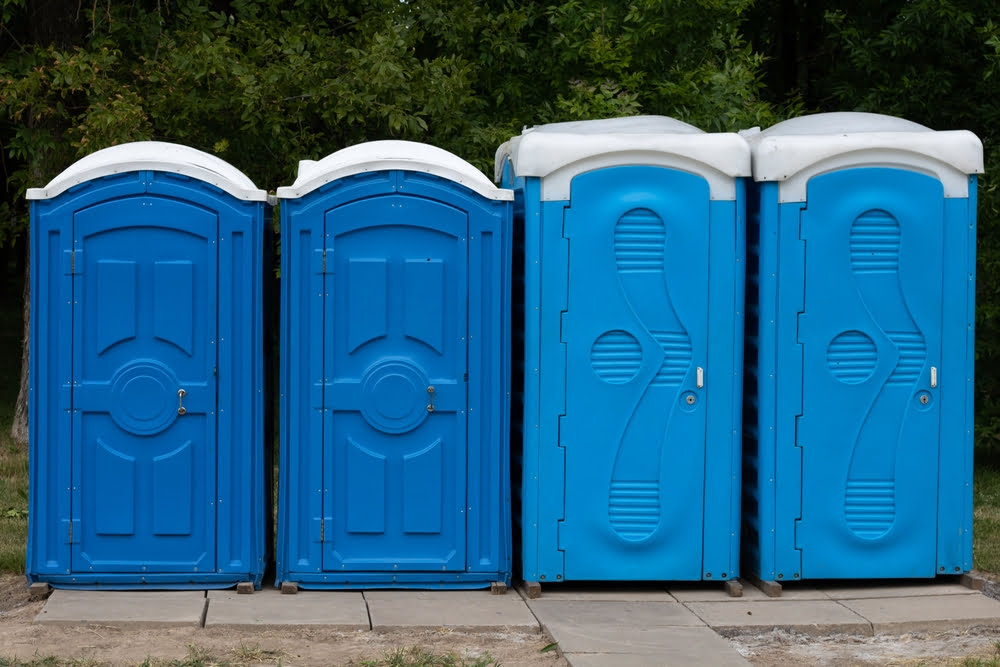 blue-public-toilets-standing-outside
